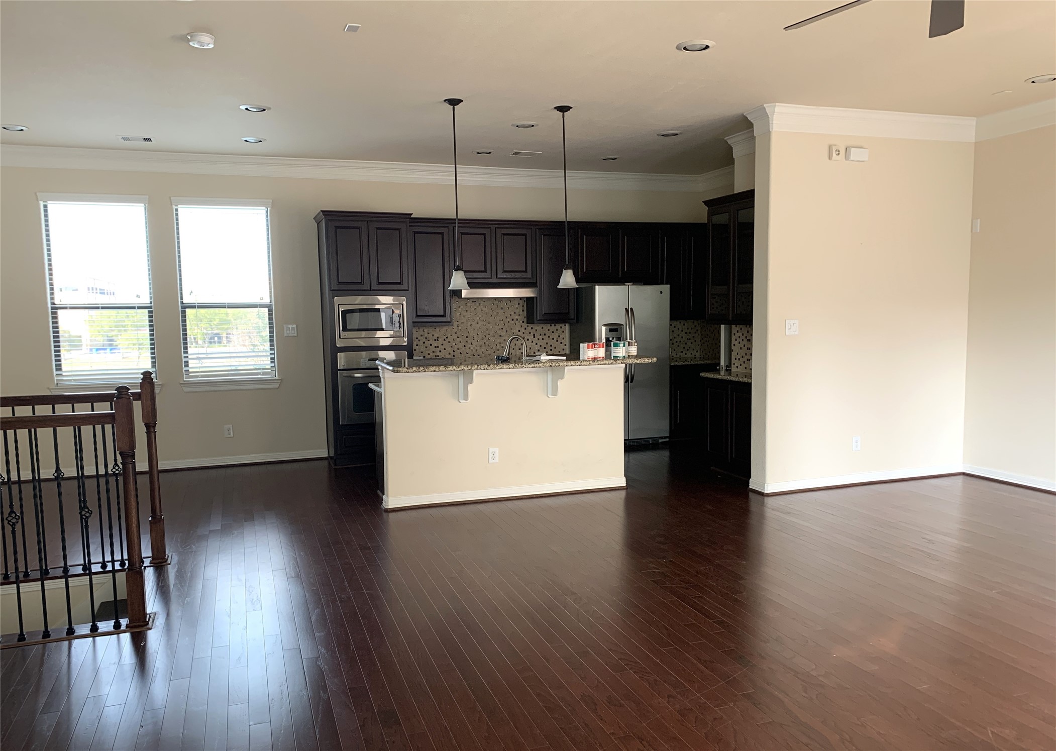 3021 Kisling Street Houston, TX 77021 - Photo 6 of 27 a kitchen with stainless steel appliances granite countertop a refrigerator a stove top oven a sink dishwasher and white cabinets with wooden floor
