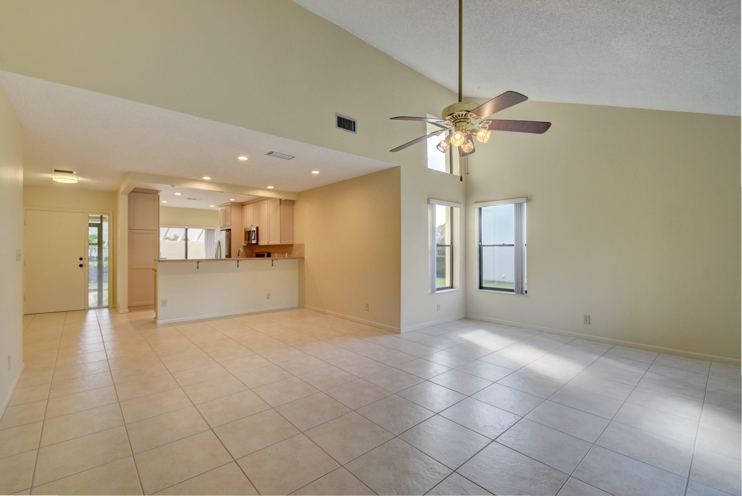 10981 Hidden Lake Place Boca Raton, FL 33498 - Photo 12 of 44 a view of a livingroom with a chandelier fan and windows