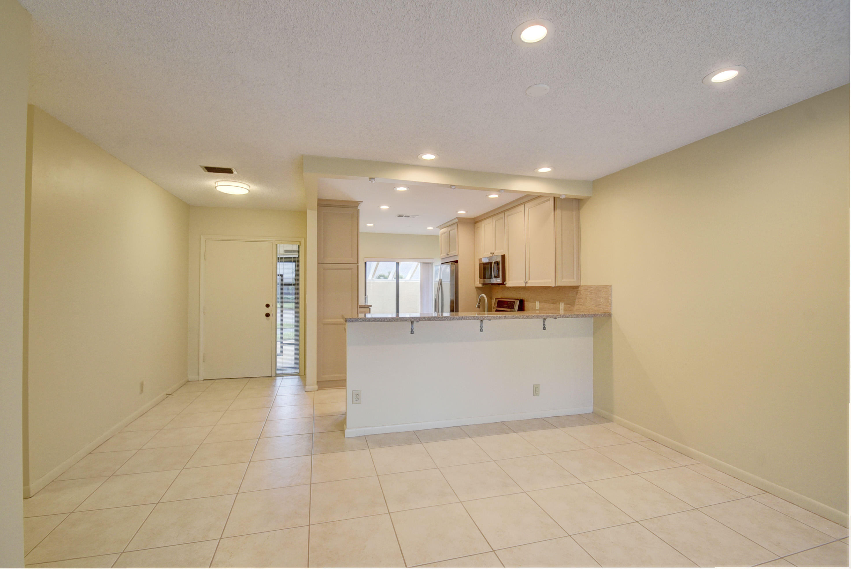 10981 Hidden Lake Place Boca Raton, FL 33498 - Photo 8 of 44 a view of open kitchen with white cabinets