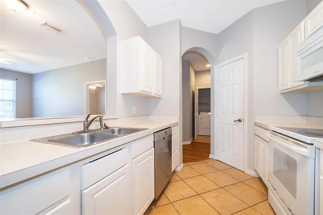 a spacious bathroom with a sink and a mirror