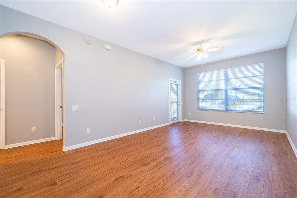 581 Brantley Terrace Way, Unit 202 Altamonte Springs, FL 32714 - Photo 13 of 25 an empty room with wooden floor and windows
