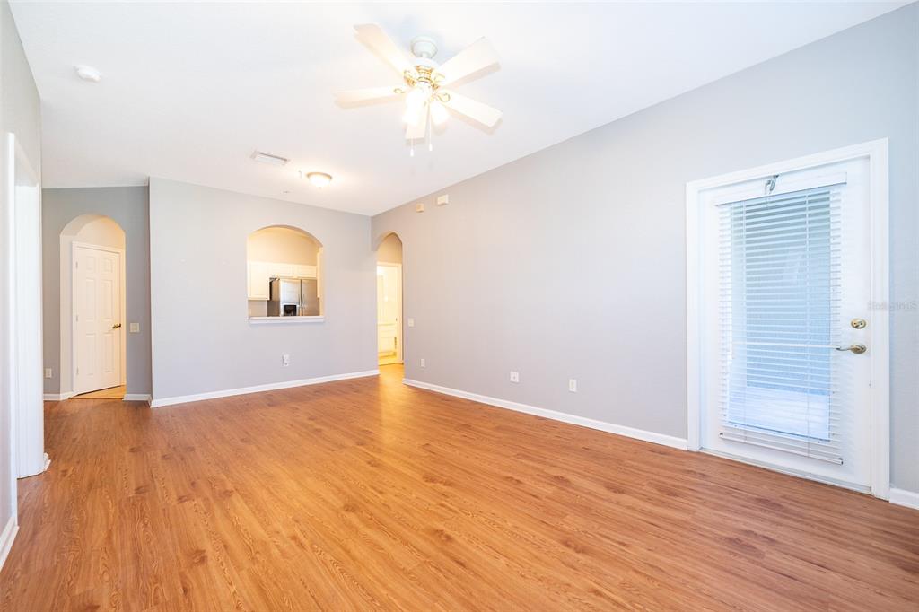 581 Brantley Terrace Way, Unit 202 Altamonte Springs, FL 32714 - Photo 15 of 25 an empty room with wooden floor and a ceiling fan