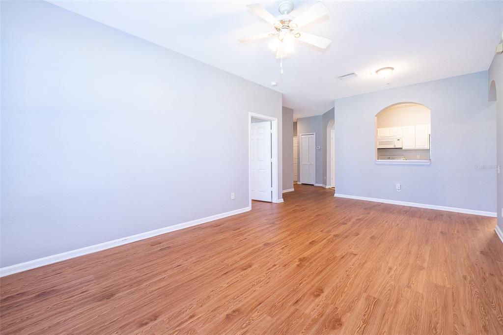 581 Brantley Terrace Way, Unit 202 Altamonte Springs, FL 32714 - Photo 16 of 25 an empty room with wooden floor and fan
