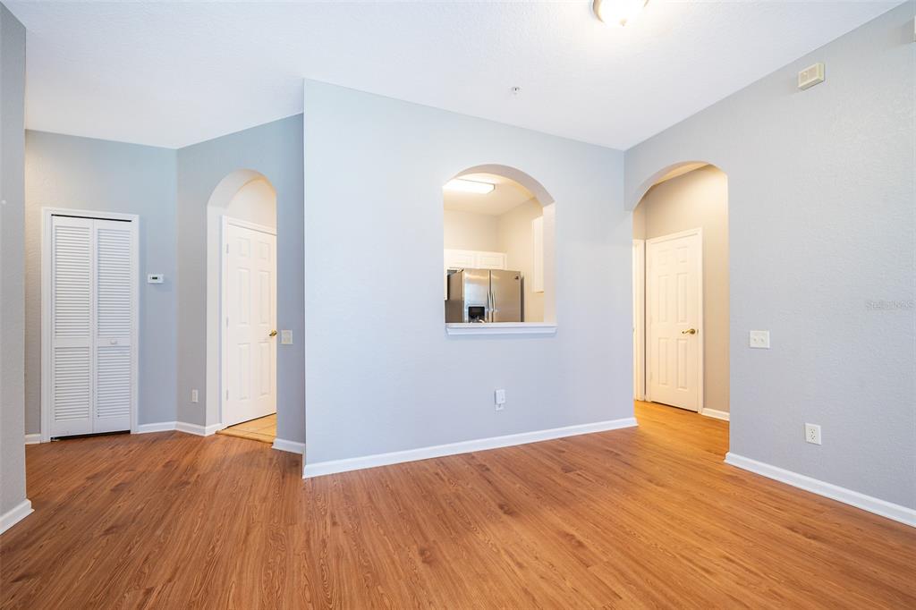 581 Brantley Terrace Way, Unit 202 Altamonte Springs, FL 32714 - Photo 17 of 25 a view of empty room with wooden floor and window