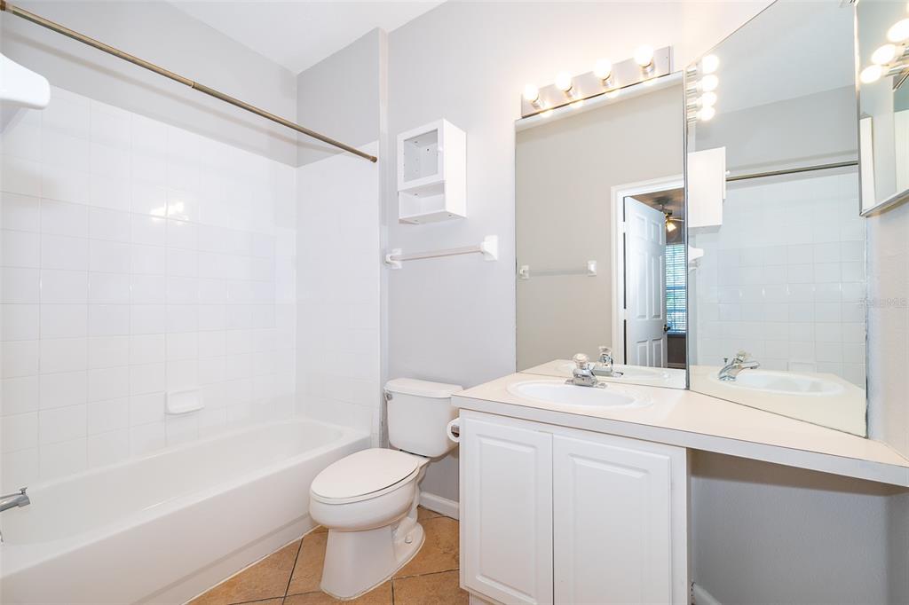 581 Brantley Terrace Way, Unit 202 Altamonte Springs, FL 32714 - Photo 19 of 25 a bathroom with a bathtub shower sink vanity mirror and toilet
