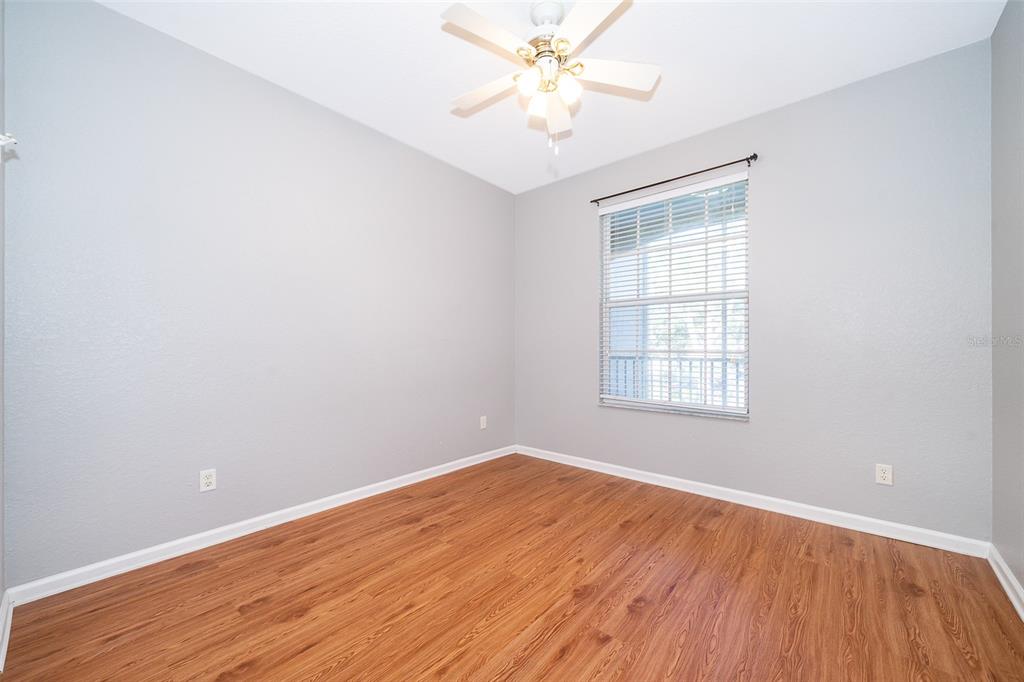 581 Brantley Terrace Way, Unit 202 Altamonte Springs, FL 32714 - Photo 21 of 25 an empty room with wooden floor and windows
