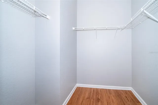 a small space with wooden floor and a window