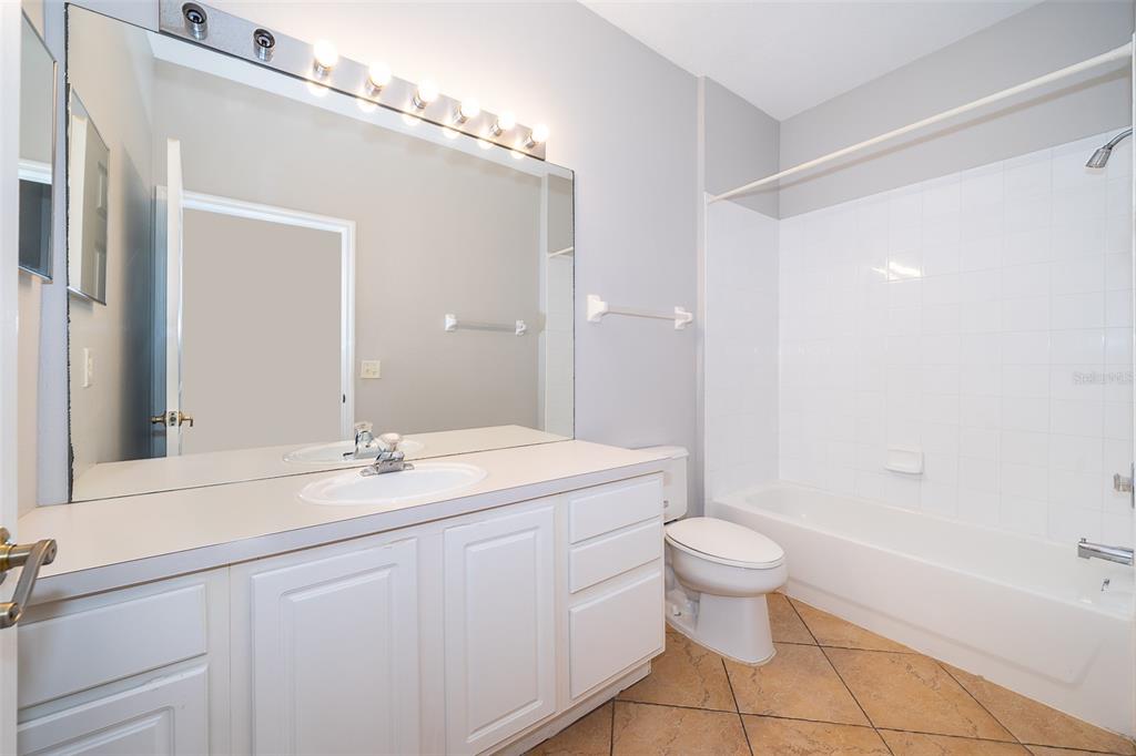 581 Brantley Terrace Way, Unit 202 Altamonte Springs, FL 32714 - Photo 23 of 25 a bathroom with a sink a toilet and a mirror