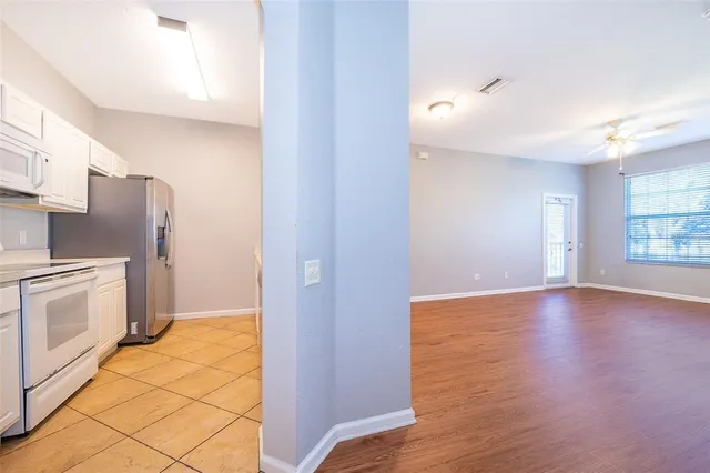 a view of a kitchen with a sink and a refrigerator