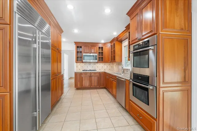 a kitchen with stainless steel appliances granite countertop a refrigerator and a sink