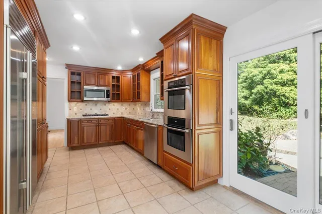 a kitchen with stainless steel appliances a refrigerator and a sink