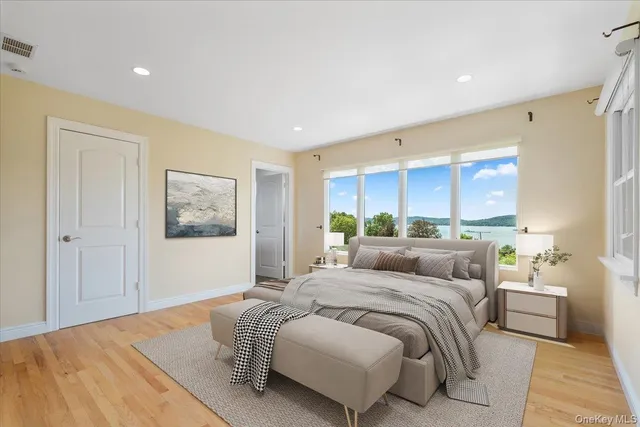 a bedroom with a large bed and a window