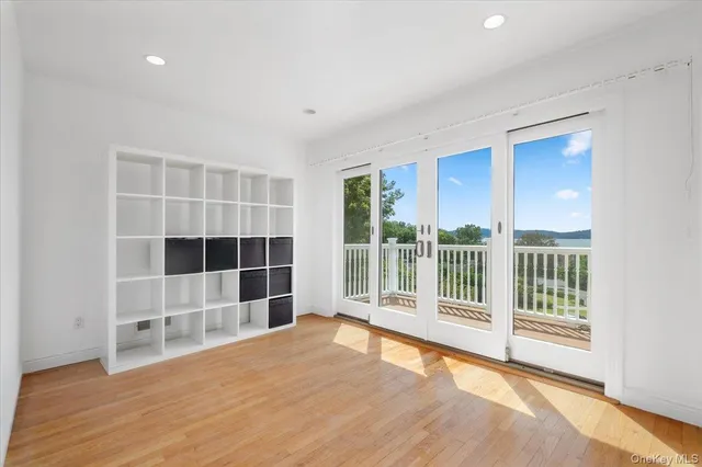 a view of wooden floor and windows in a room