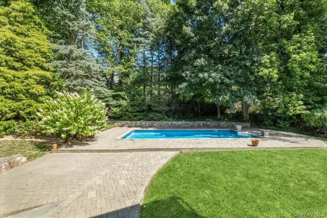 a view of a swimming pool with an outdoor space and seating area