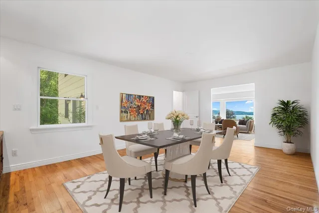 a dining room with furniture potted plants and wooden floor