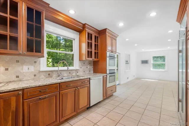 a kitchen with a sink window and cabinets