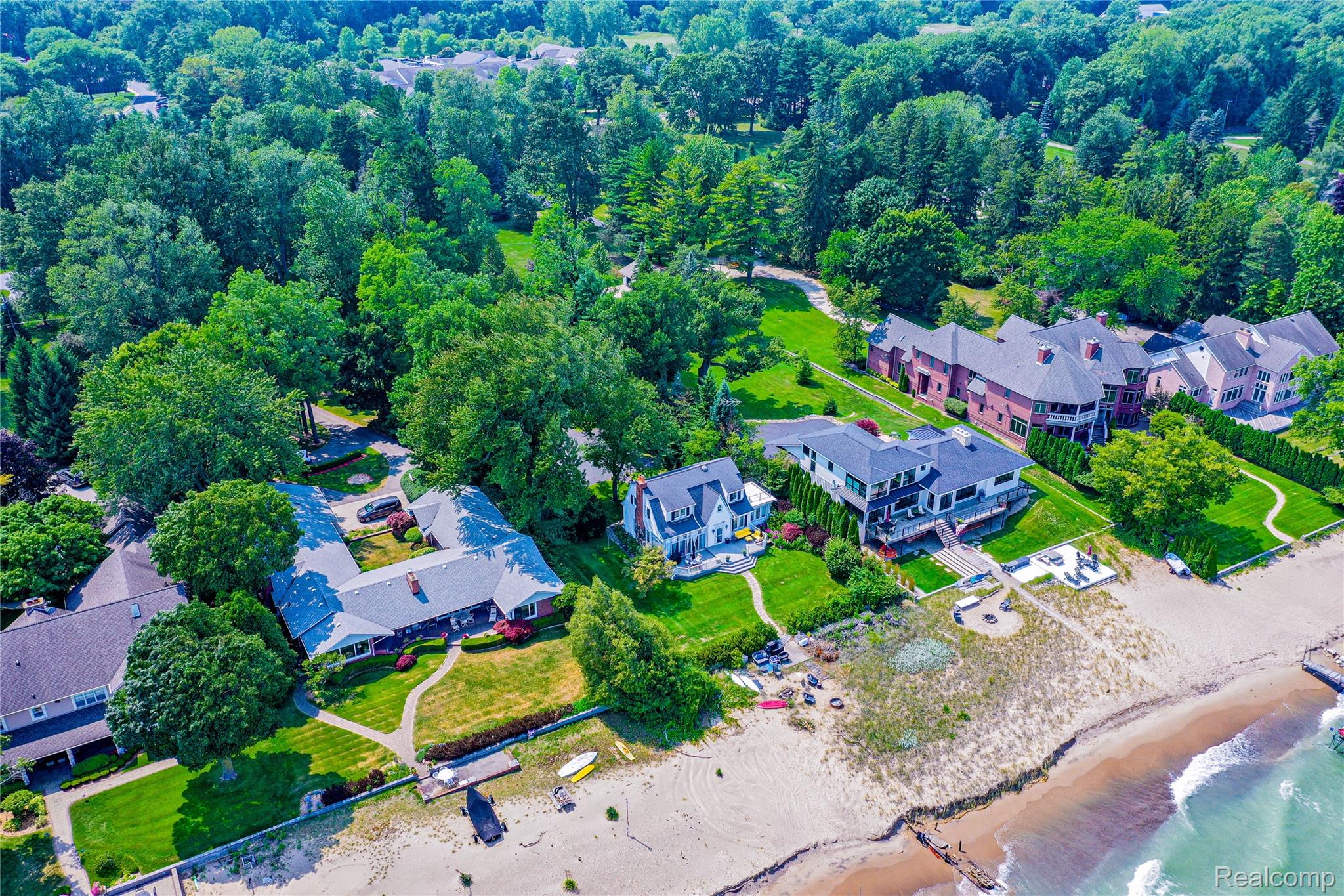 5630 Lakeshore Road Fort Gratiot, MI 48059 - Photo 39 of 49 Waterfront property featuring a private sandy beach, multiple residences, lush green lawns, mature trees, and direct water access