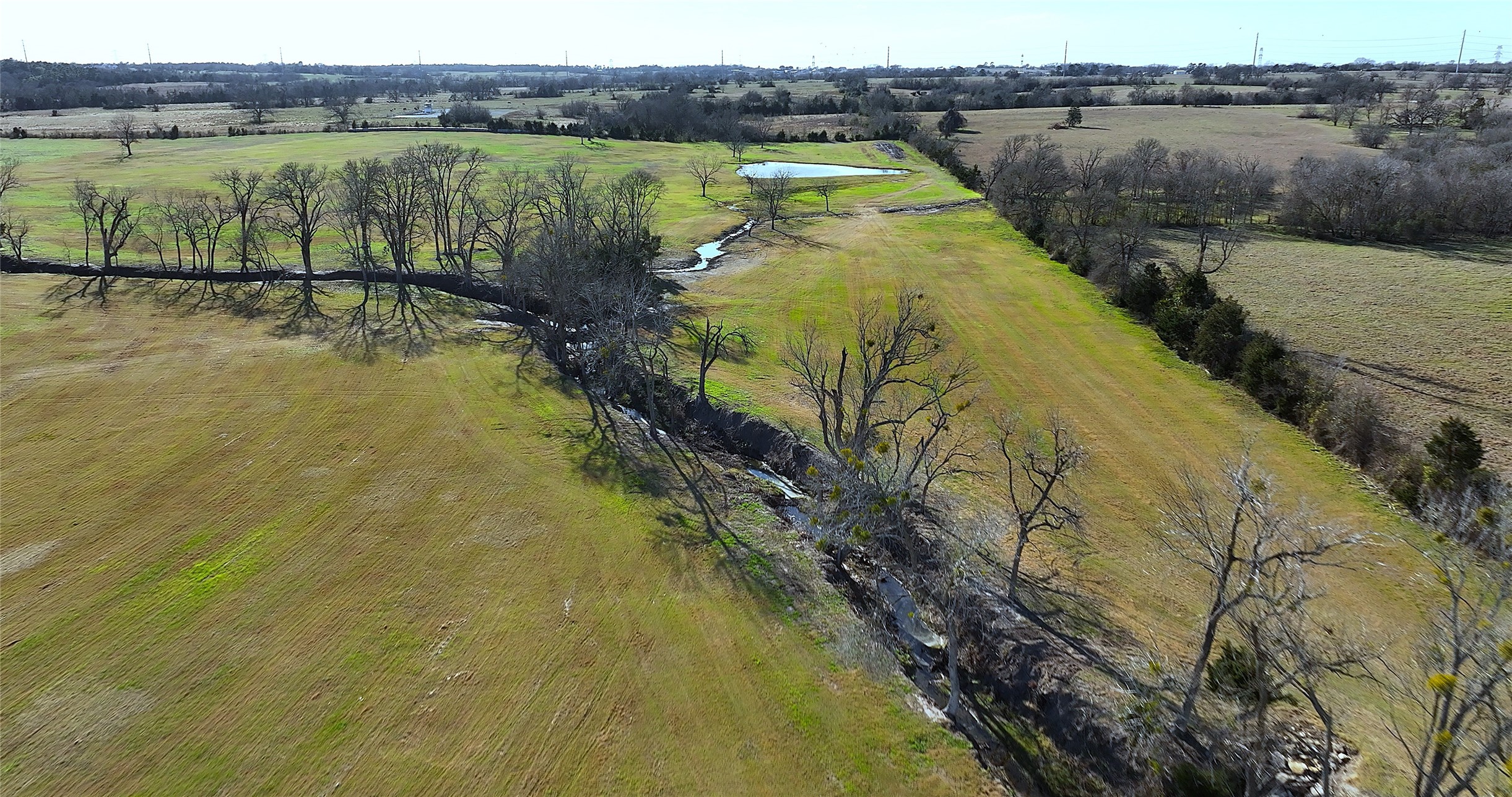 3283-40 Fm 2562 Road Anderson, TX 77830 - Photo 18 of 23 a view of a lake with a yard and large trees