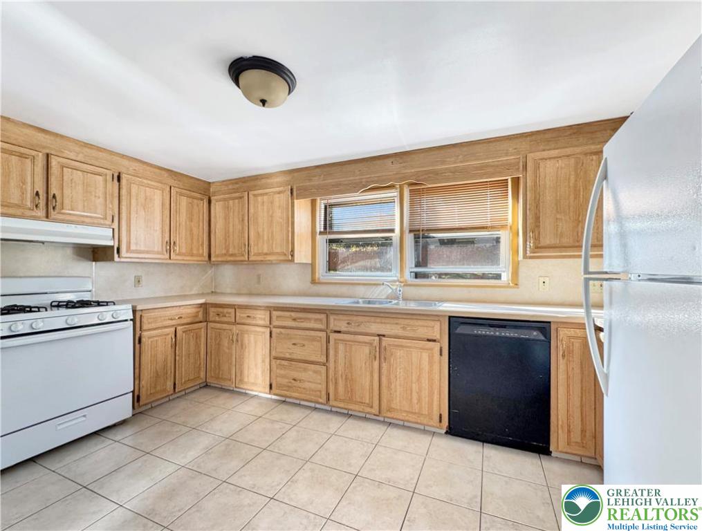 257 East 2nd Street Wind Gap, PA 18091 - Photo 5 of 14 a kitchen with granite countertop cabinets stainless steel appliances and a window