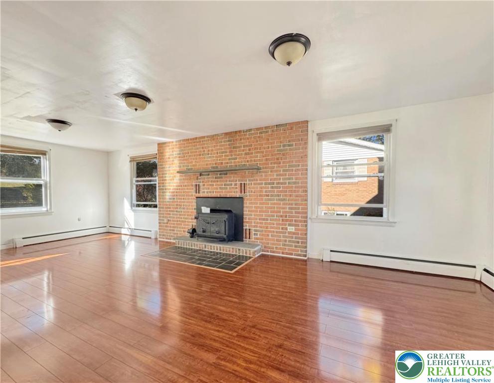 257 East 2nd Street Wind Gap, PA 18091 - Photo 7 of 14 a view of empty room with a fireplace and wooden floor