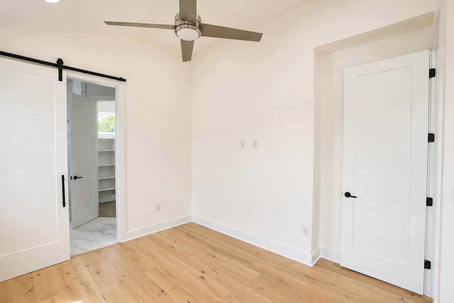 1123 Omega Avenue, Unit 1 Austin, TX 78721 - Photo 23 of 40 Light wood-finish flooring with white baseboards and neutral wall tones