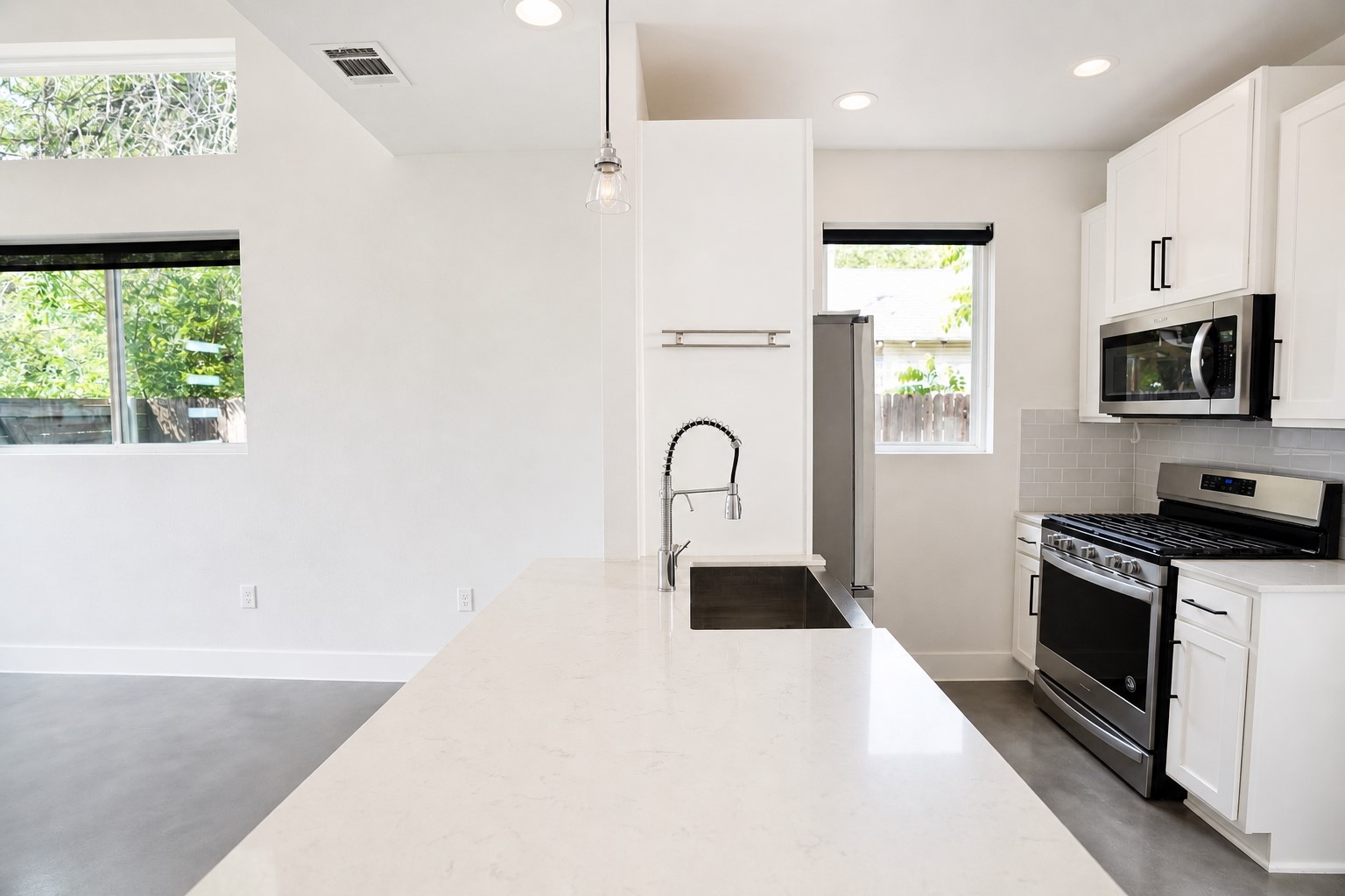 1123 Omega Avenue, Unit 1 Austin, TX 78721 - Photo 9 of 40 Kitchen island with a white countertop and an undermount sink