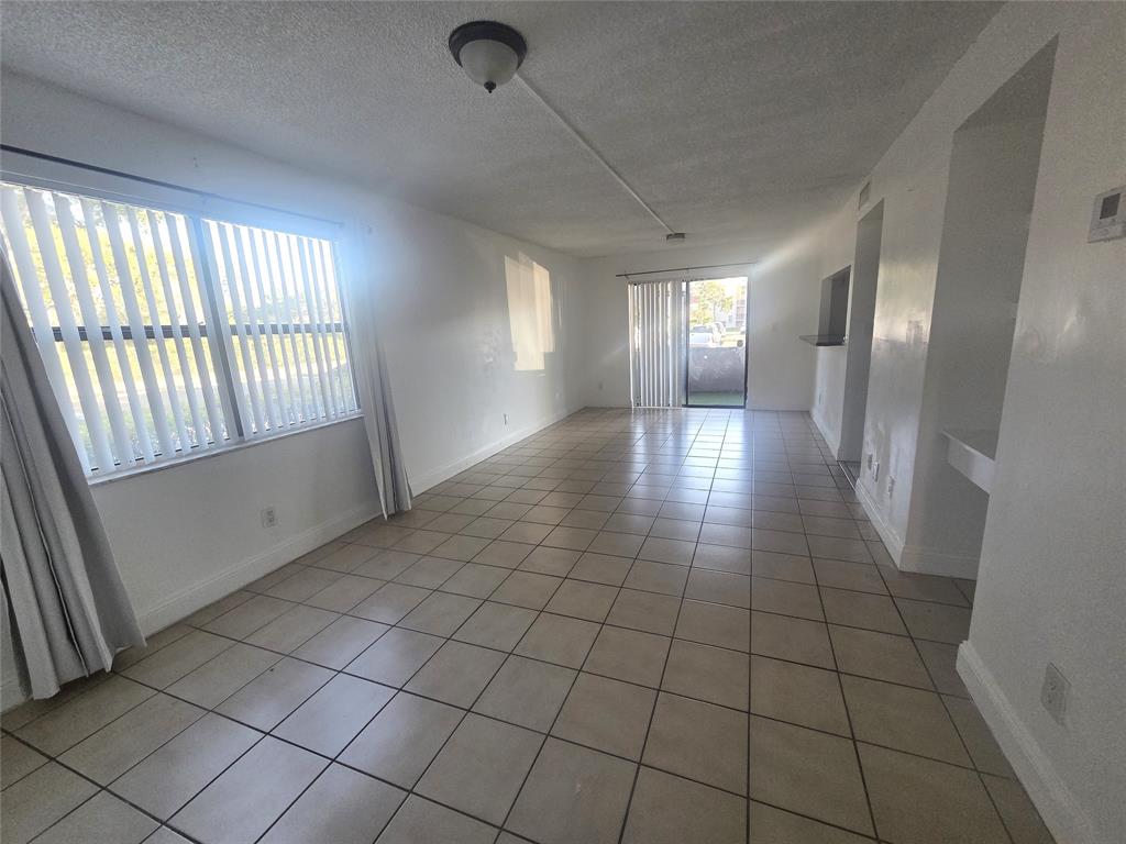 3252 Foxcroft Road, Unit 101 Miramar, FL 33025 - Photo 3 of 15 a view of entryway and hall with a window