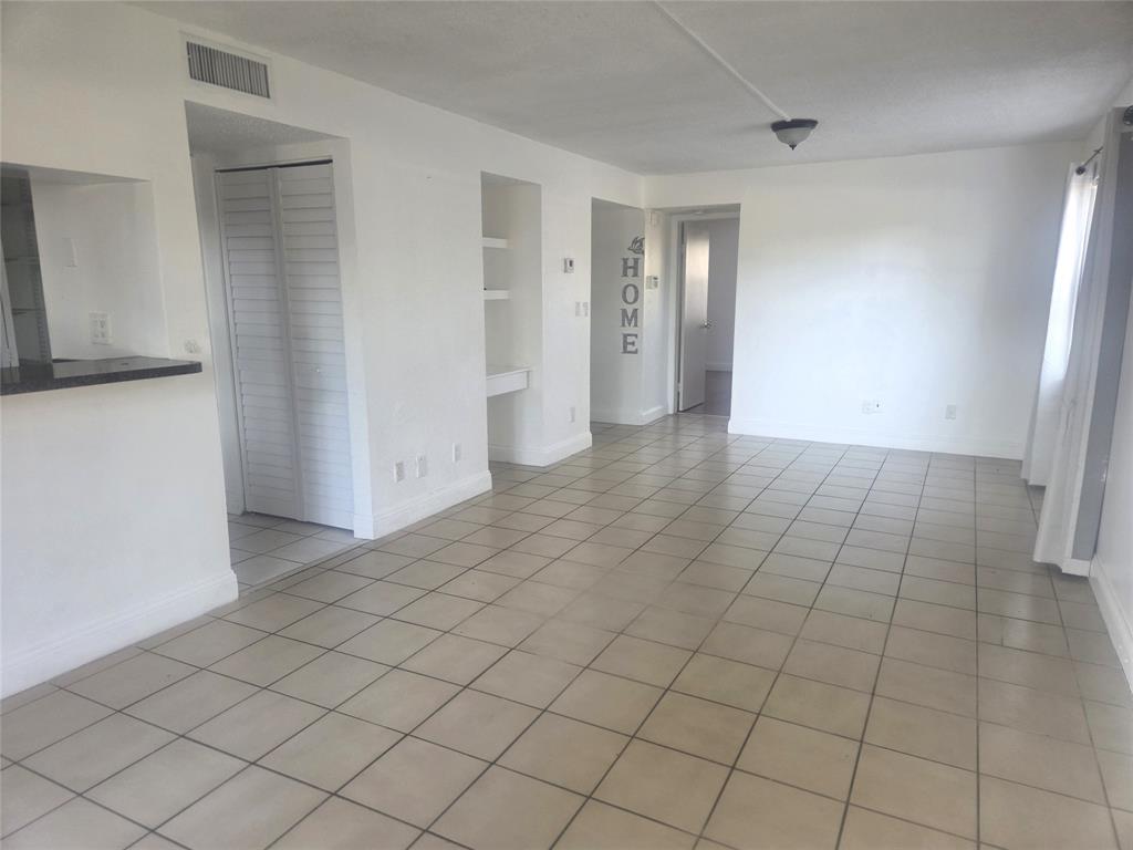 3252 Foxcroft Road, Unit 101 Miramar, FL 33025 - Photo 9 of 15 an empty room with a natural light