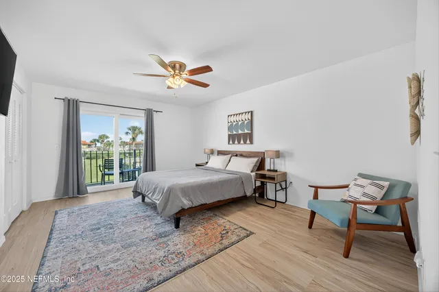 a bed room with a bed and a chair