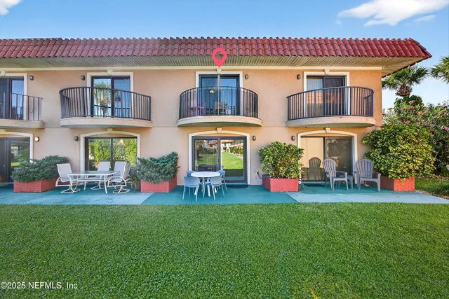 a front view of house with outdoor seating and yard
