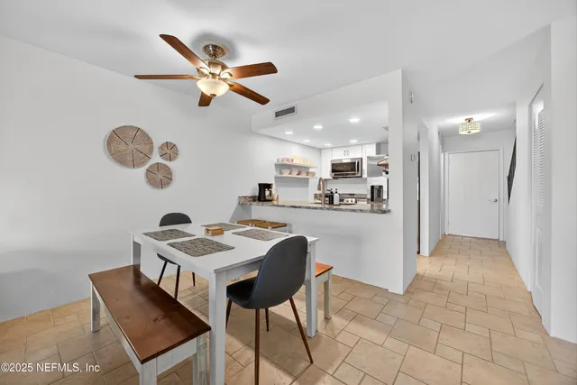 a kitchen with a table and chairs