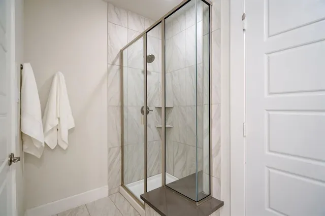 a bathroom with a shower and a sink