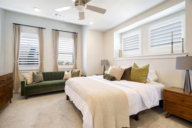 a bedroom with bed and windows