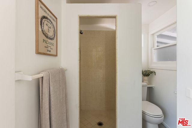 a white toilet sitting next to a bathroom sink