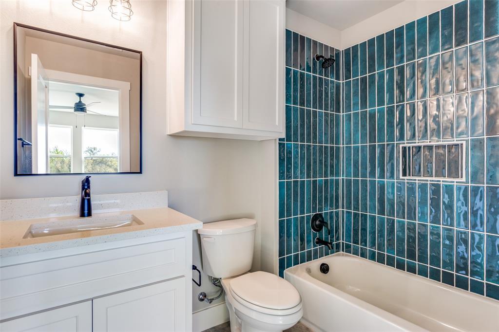 555 Aermotor Loop Weatherford, TX 76085 - Photo 29 of 30 a bathroom with a toilet a sink and mirror