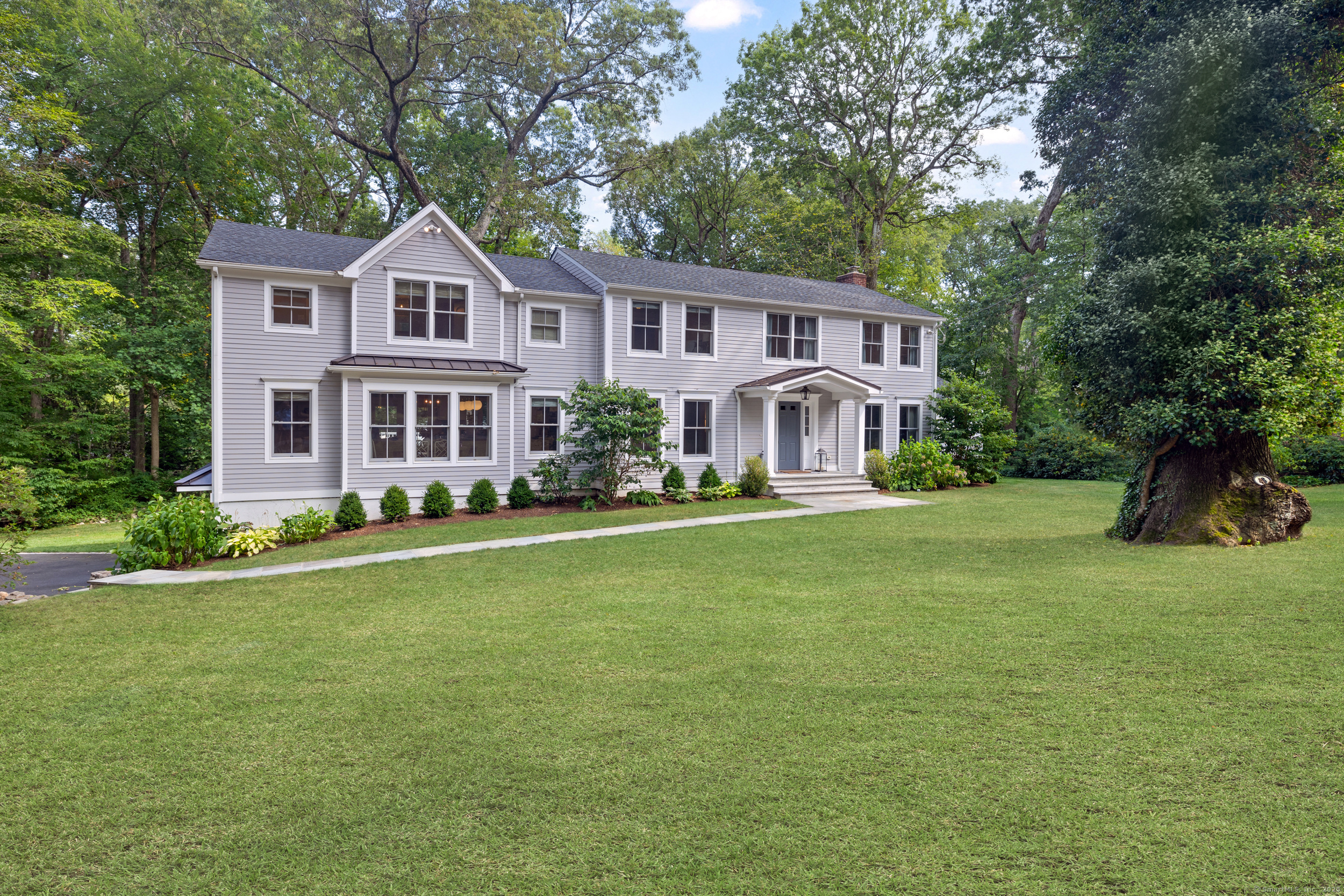 48 Silver Ridge Road New Canaan, CT 06840 - Photo 1 of 1 a front view of a house with a garden