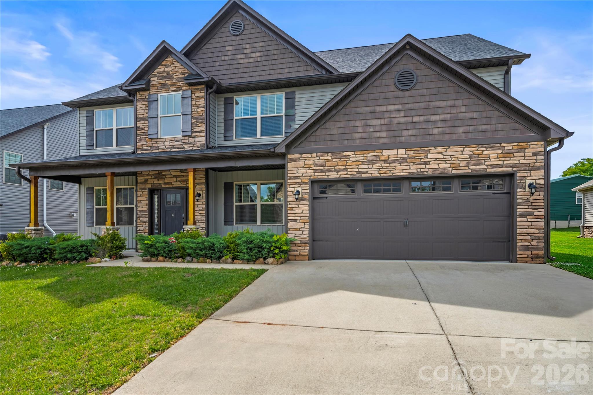 4 Henbit Way Arden, NC 28704 - Photo 1 of 38 a front view of a house with a yard and garage