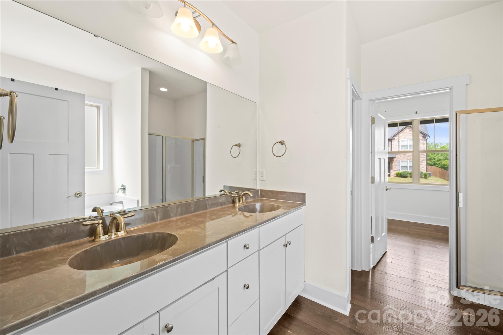 4 Henbit Way Arden, NC 28704 - Photo 14 of 38 a bathroom with a granite countertop sink and a mirror