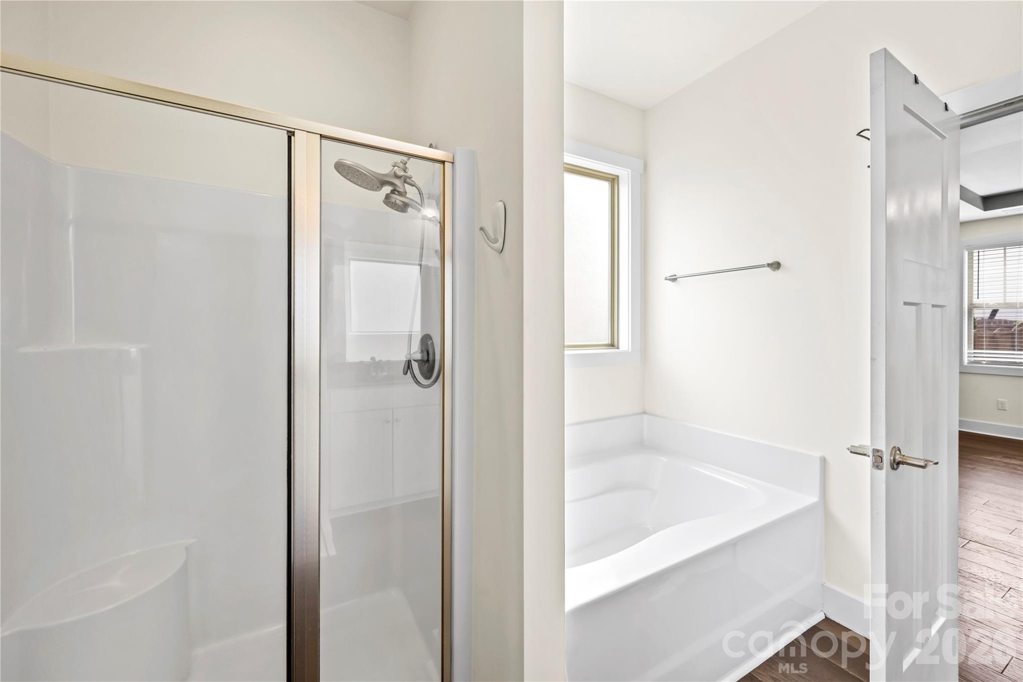 4 Henbit Way Arden, NC 28704 - Photo 15 of 38 a bathroom with a glass shower door