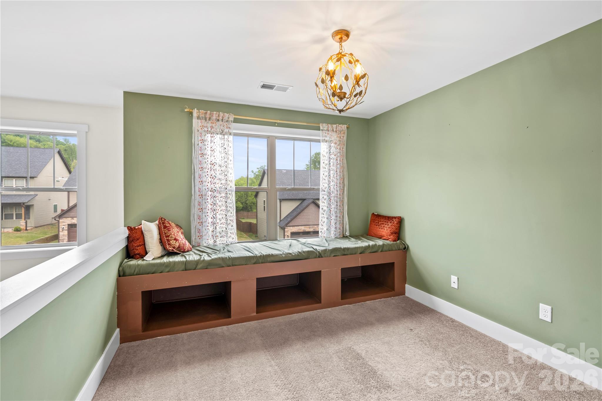 4 Henbit Way Arden, NC 28704 - Photo 19 of 38 a living room with stainless steel appliances kitchen island a chandelier
