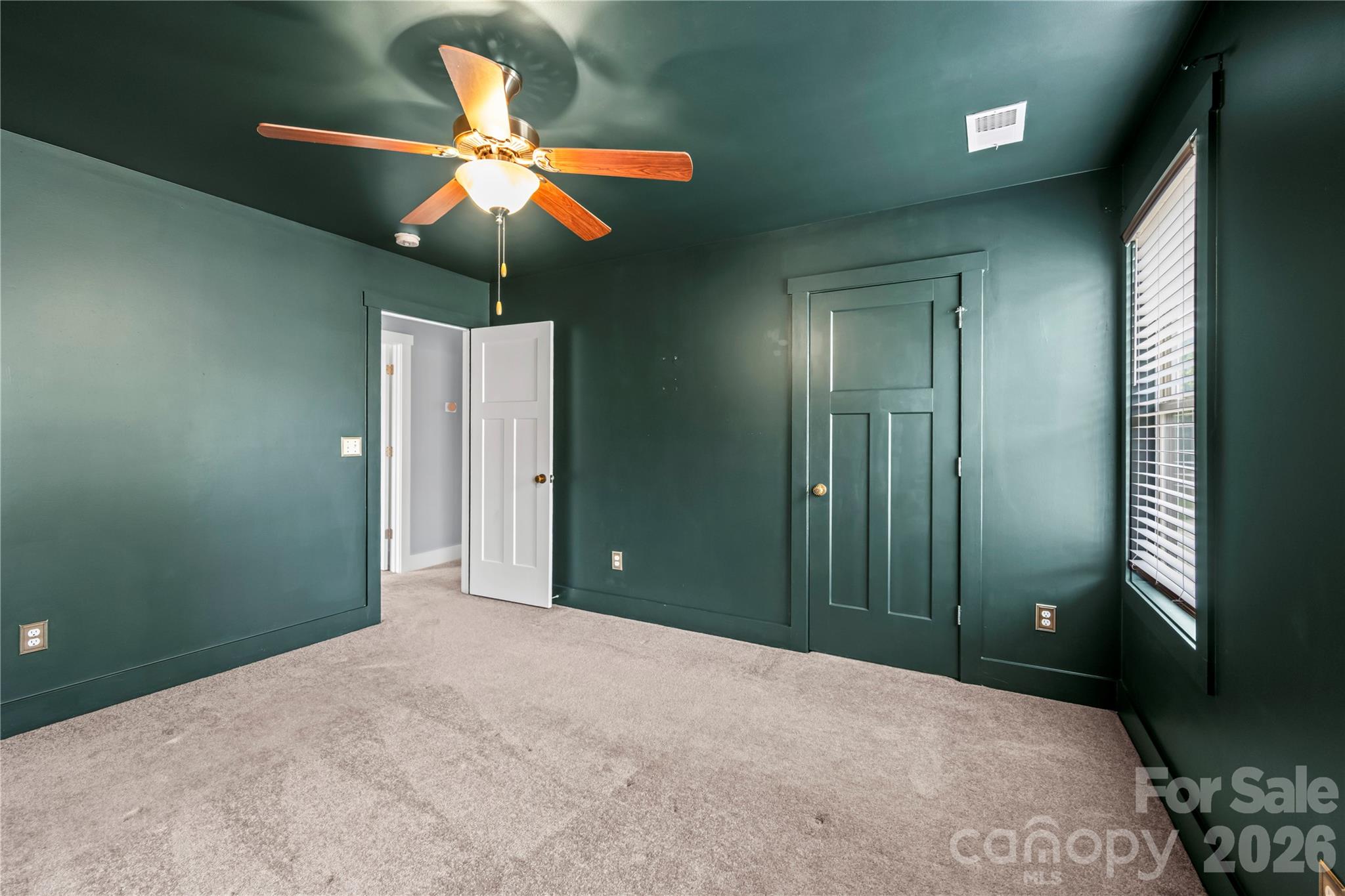 4 Henbit Way Arden, NC 28704 - Photo 26 of 38 a workspace with a chandelier fan and a bathroom