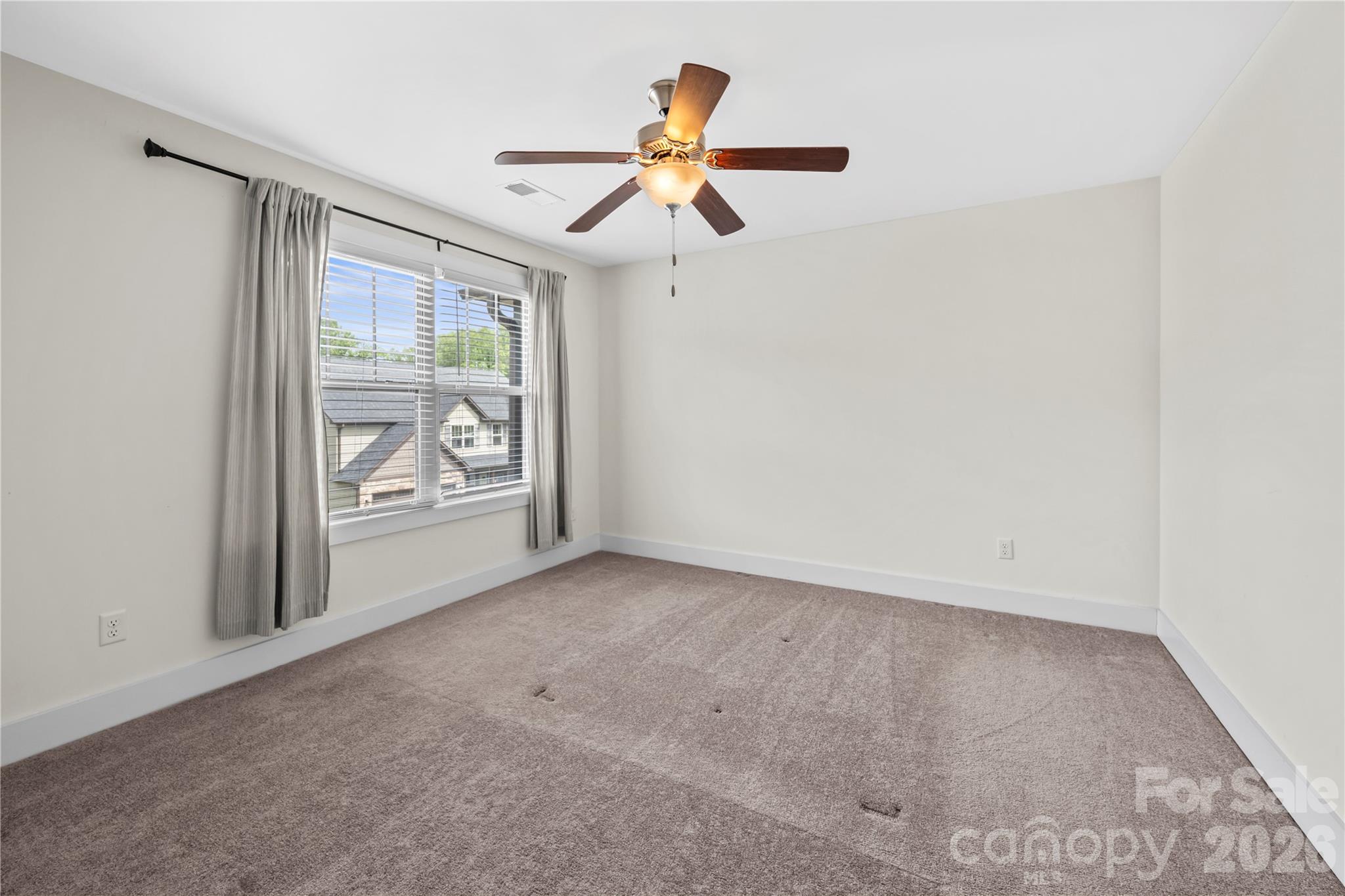 4 Henbit Way Arden, NC 28704 - Photo 29 of 38 an empty room with fan and windows