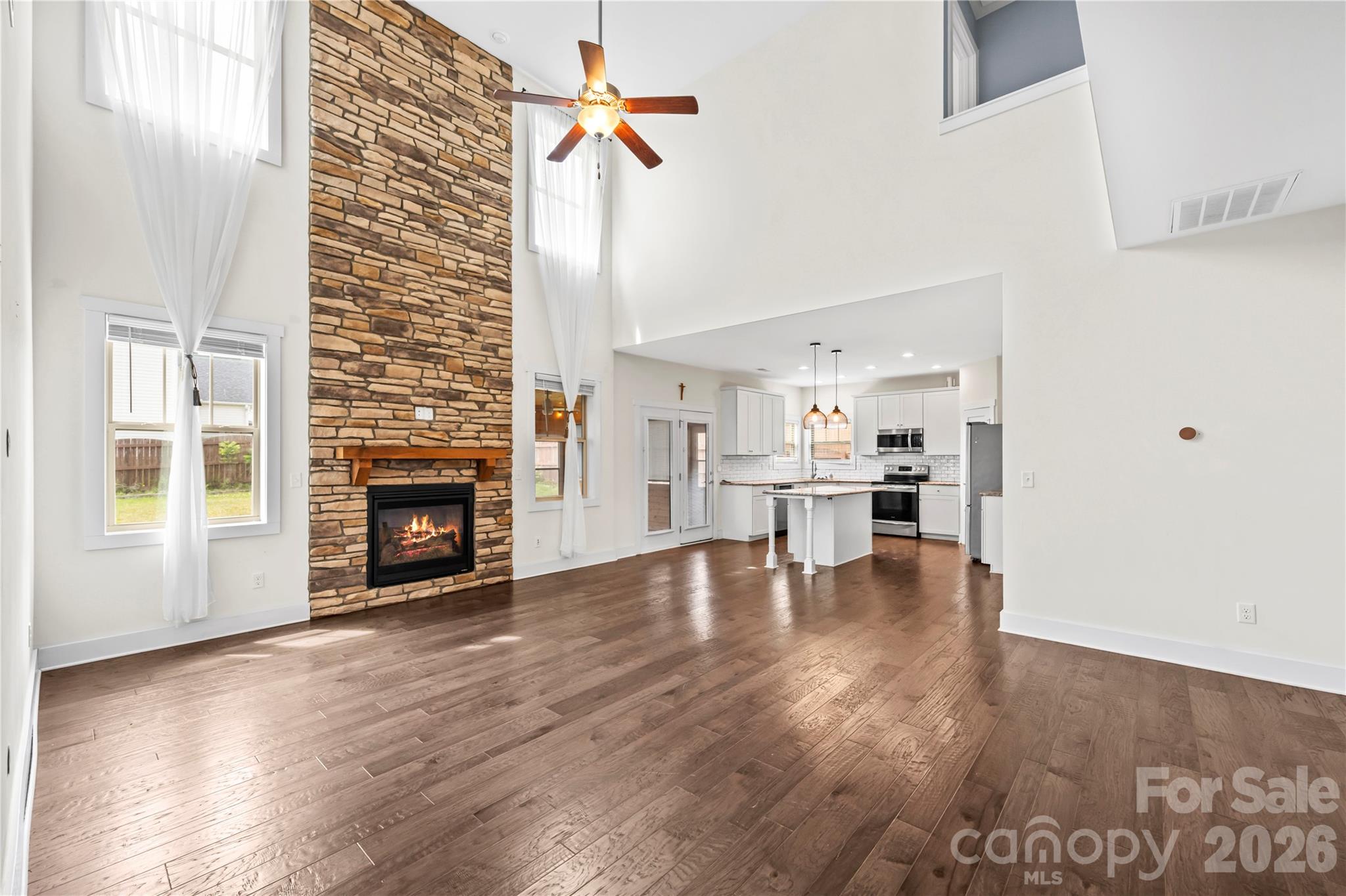 4 Henbit Way Arden, NC 28704 - Photo 3 of 38 a view of empty room with wooden floor and fireplace