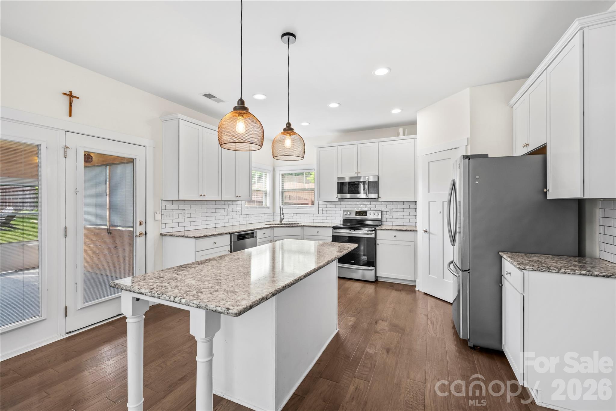 4 Henbit Way Arden, NC 28704 - Photo 6 of 38 a kitchen with granite countertop a sink a counter space stainless steel appliances and cabinets