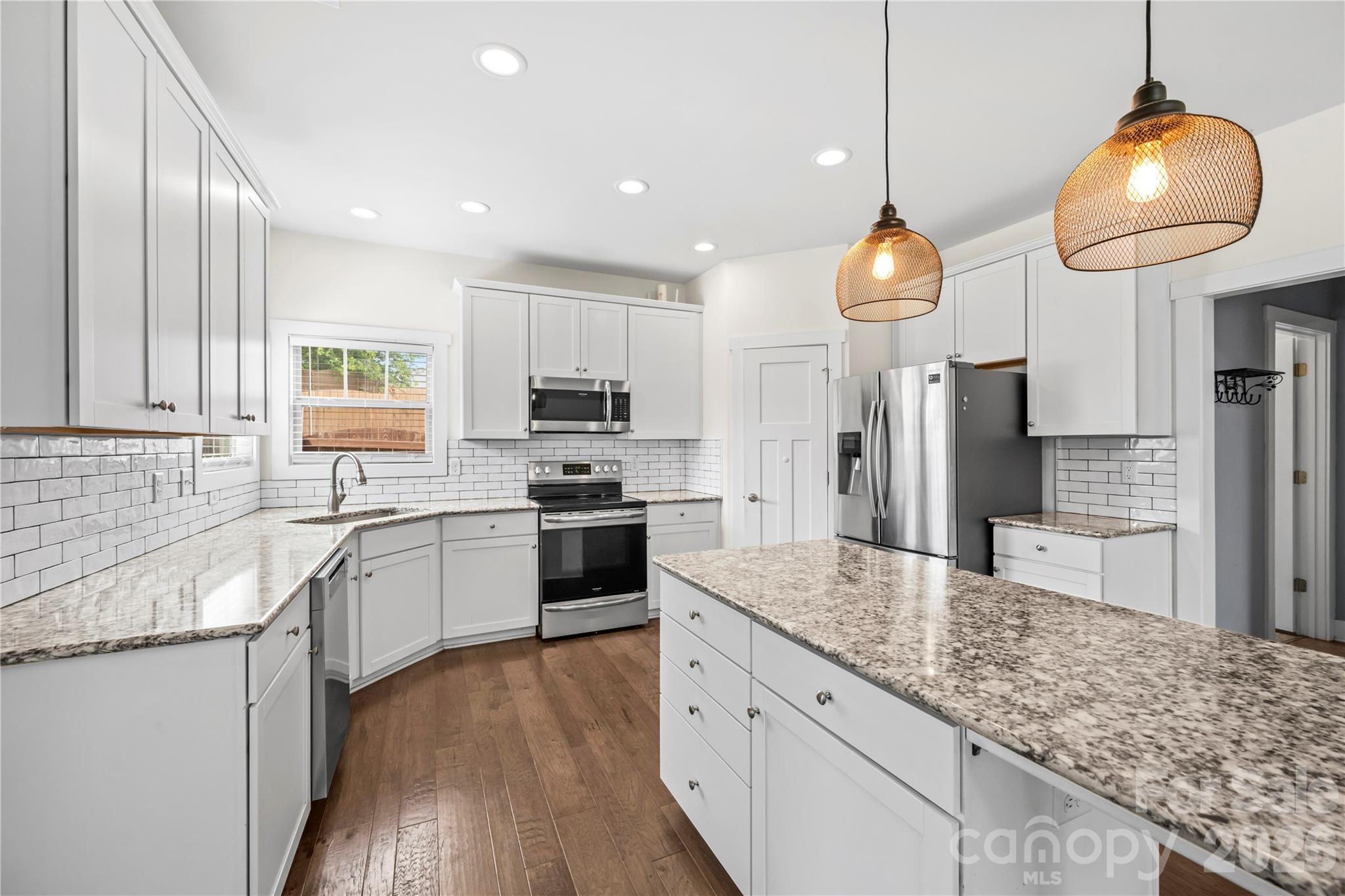 4 Henbit Way Arden, NC 28704 - Photo 8 of 38 a kitchen with stainless steel appliances granite countertop a sink refrigerator and cabinets