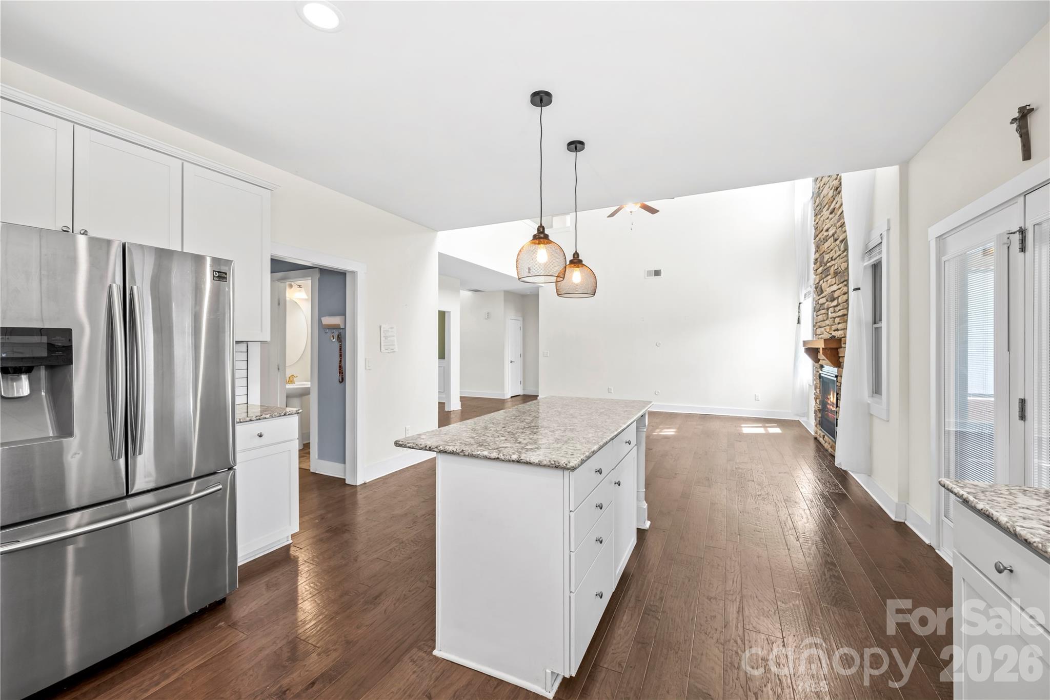 4 Henbit Way Arden, NC 28704 - Photo 9 of 38 a kitchen with stainless steel appliances granite countertop a refrigerator a sink dishwasher and white cabinets with wooden floor