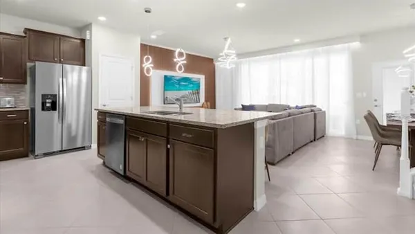a kitchen with granite countertop stainless steel appliances and wood cabinets