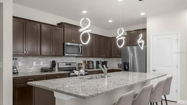 a kitchen with a sink and a counter top space