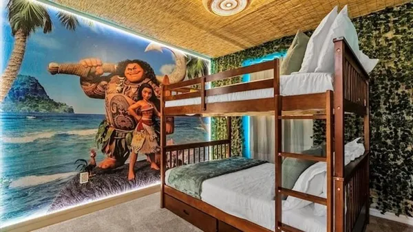 a view of a room that has painting on the wall