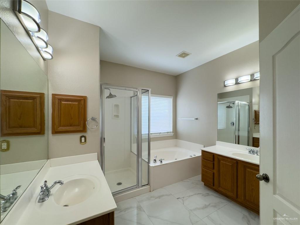 3402 San Sebastian Street Mission, TX 78572 - Photo 12 of 37 a bathroom with a tub sink and mirror